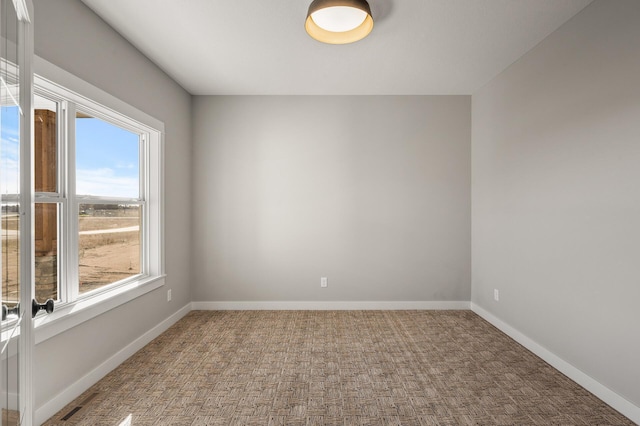 carpeted empty room featuring a healthy amount of sunlight