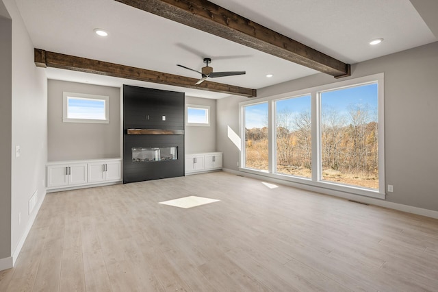 unfurnished living room with beam ceiling, light hardwood / wood-style flooring, a large fireplace, and ceiling fan