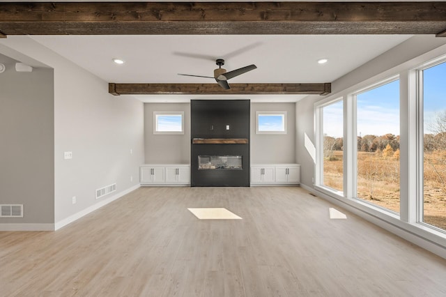 unfurnished living room featuring beamed ceiling, light hardwood / wood-style flooring, and ceiling fan