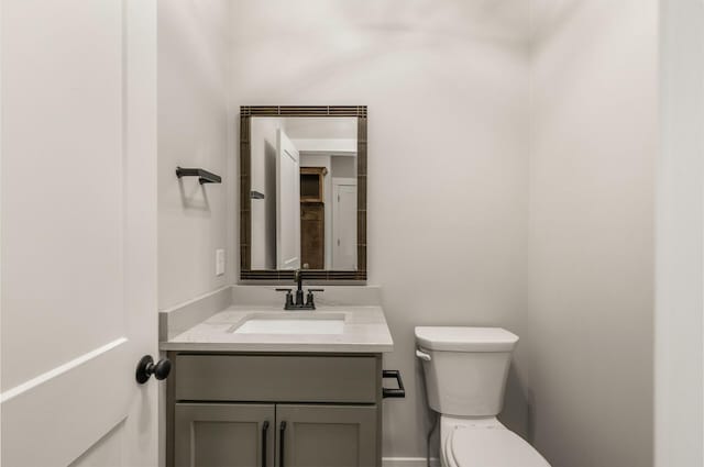 bathroom featuring toilet and vanity