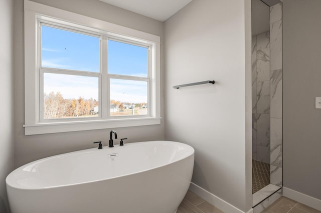 bathroom featuring shower with separate bathtub, tile patterned flooring, and a wealth of natural light