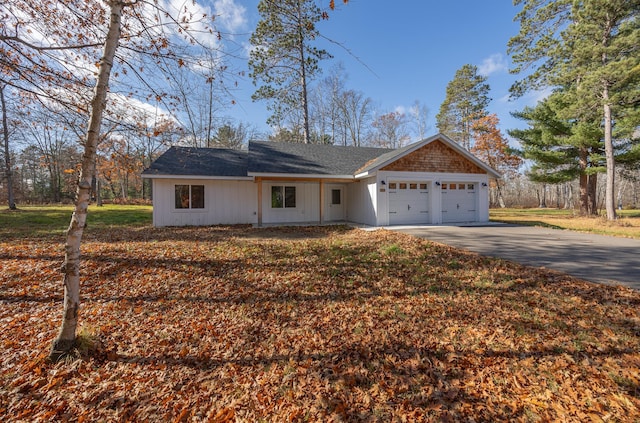 view of front of house with a garage and a front lawn