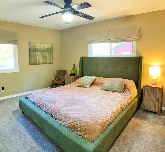 carpeted bedroom with multiple windows and ceiling fan