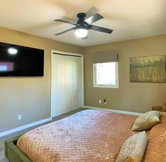 carpeted bedroom with ceiling fan and a closet