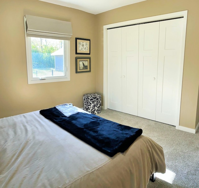 bedroom with light carpet and a closet