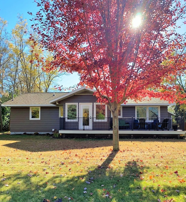 view of front of house with a front lawn and a wooden deck