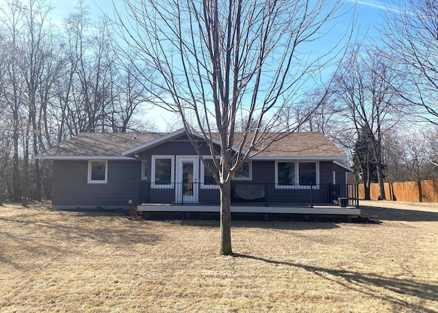 view of front of house featuring a front yard, fence, and a wooden deck