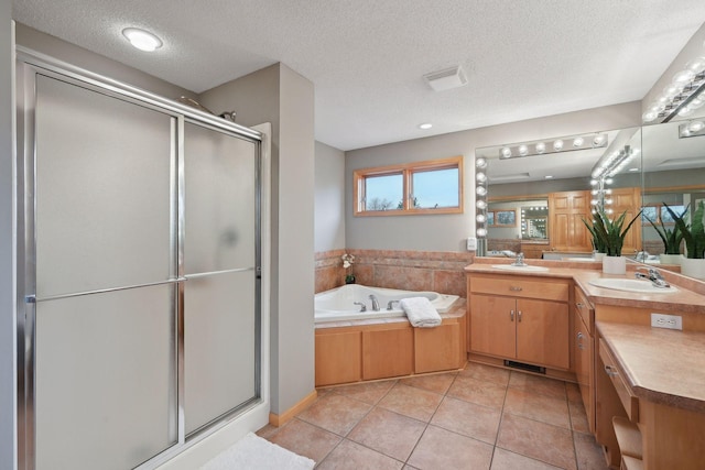 bathroom featuring vanity, a textured ceiling, tile patterned floors, and plus walk in shower