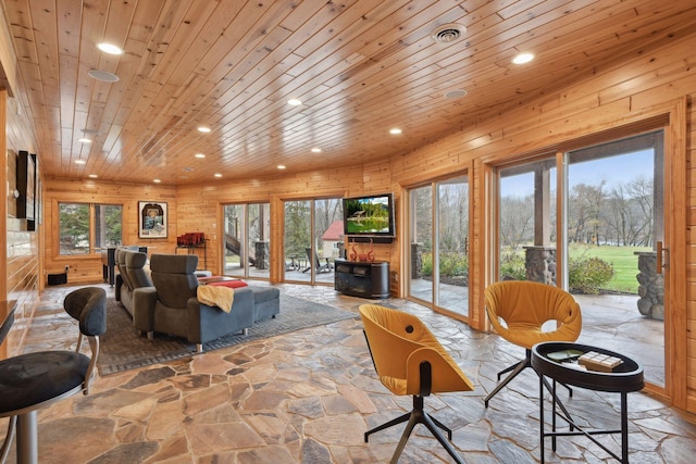 living room with wood walls and wood ceiling