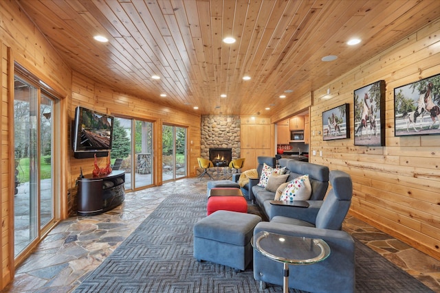 interior space featuring a fireplace, wooden walls, and wooden ceiling