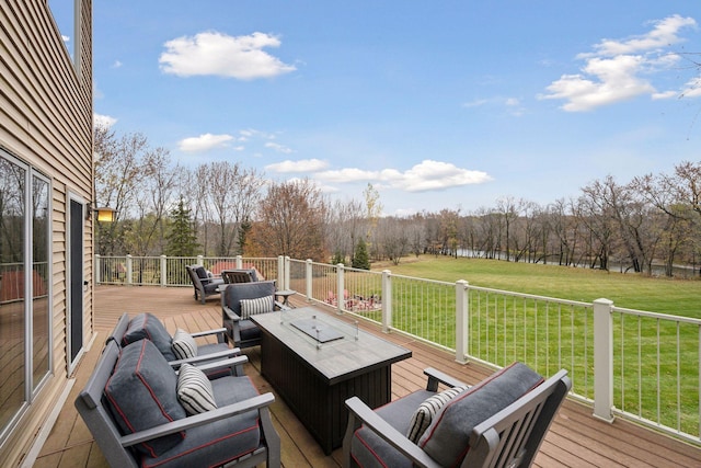 wooden deck featuring an outdoor living space with a fire pit and a yard