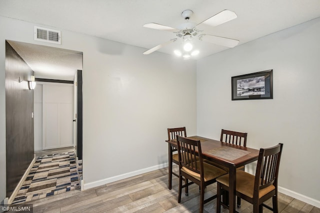 dining room with hardwood / wood-style floors and ceiling fan