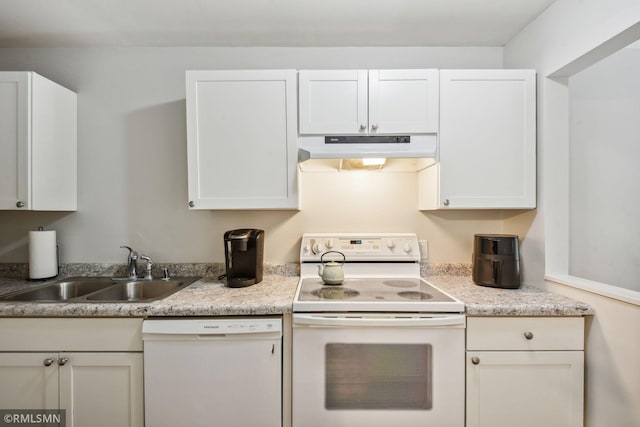 kitchen with white appliances, sink, and white cabinets