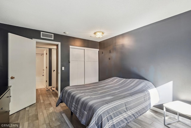 bedroom featuring a closet and wood-type flooring