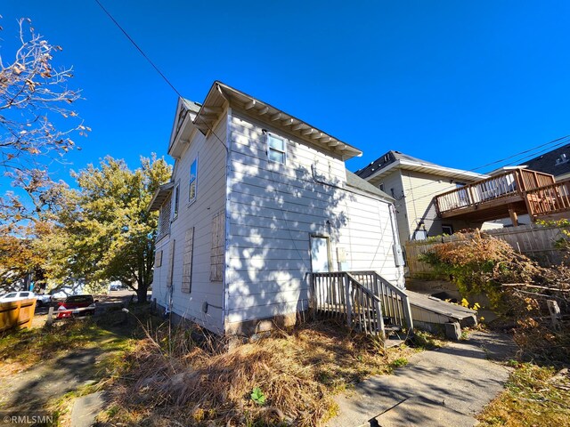 view of property exterior featuring a wooden deck