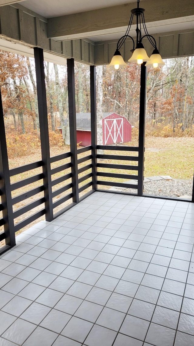 unfurnished sunroom with beamed ceiling