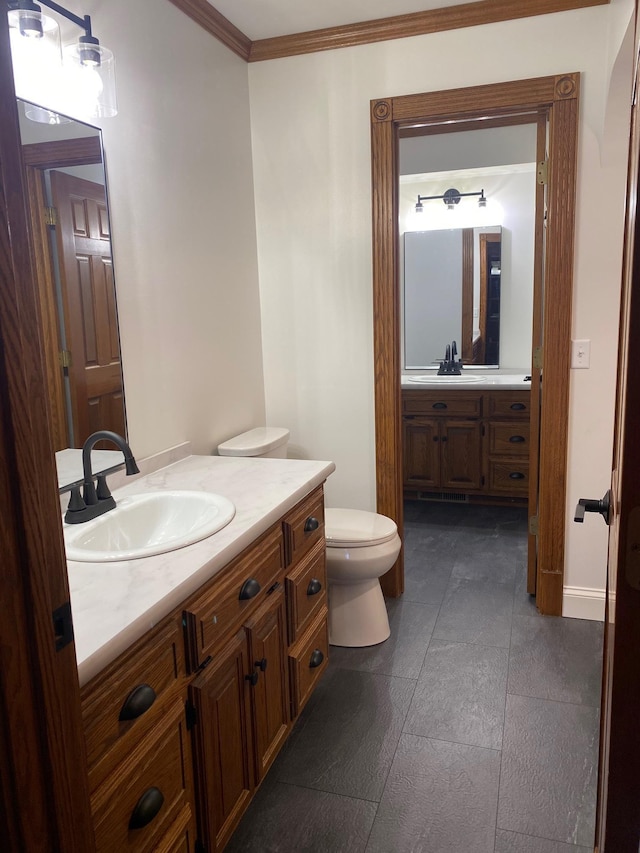 bathroom featuring vanity, crown molding, toilet, and tile patterned flooring