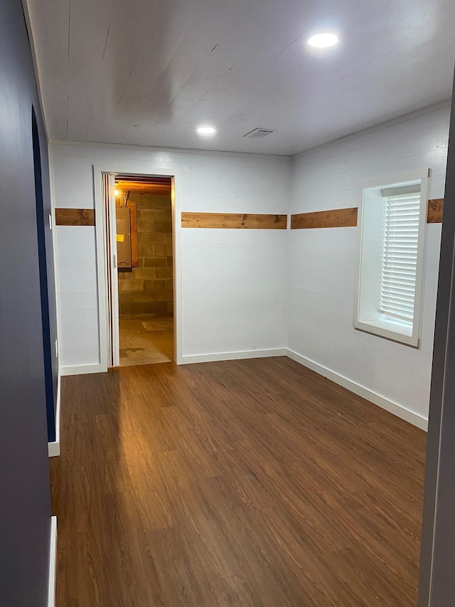 spare room with dark hardwood / wood-style flooring