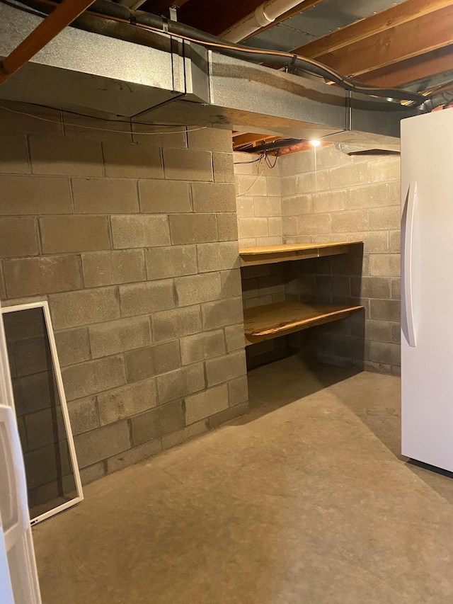 basement featuring white refrigerator