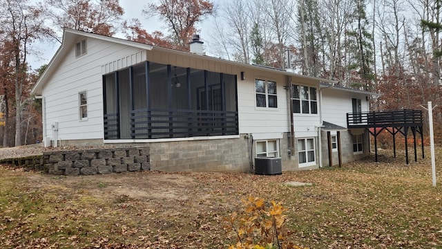 back of property featuring a sunroom and central AC