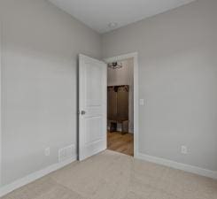 unfurnished room featuring light colored carpet