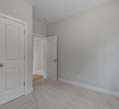 unfurnished bedroom featuring light colored carpet