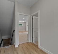 hall with hardwood / wood-style flooring