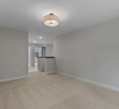 empty room featuring light carpet