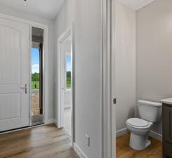 bathroom featuring hardwood / wood-style floors, vanity, and toilet