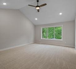 empty room with light carpet, ceiling fan, and lofted ceiling