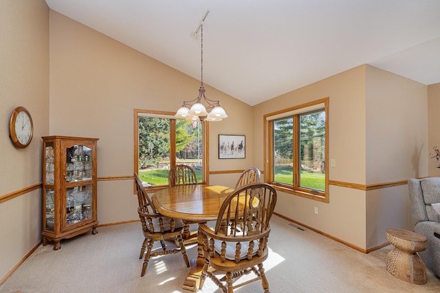 dining area featuring visible vents, light colored carpet, an inviting chandelier, and vaulted ceiling