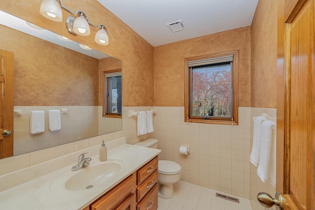 bathroom with vanity, tile patterned floors, toilet, and visible vents