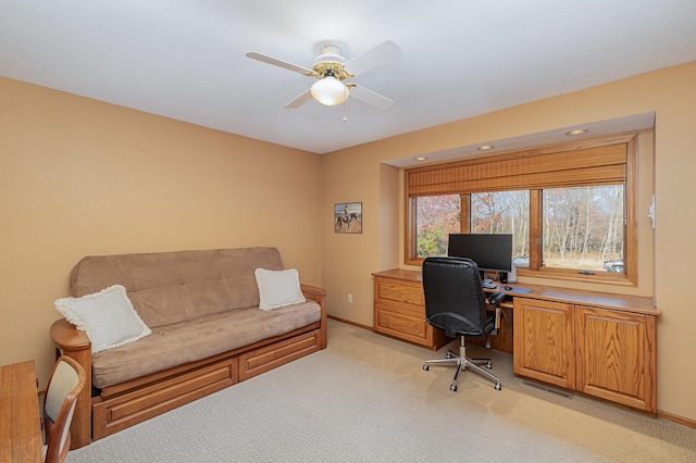 office area with baseboards, light colored carpet, and ceiling fan