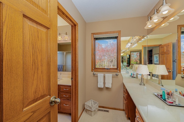 bathroom with visible vents, vanity, and baseboards