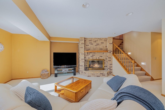 living room featuring stairway, a fireplace, baseboards, and carpet