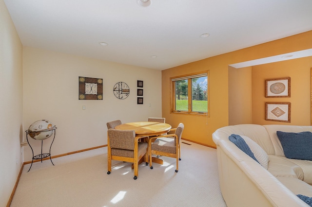 dining room featuring recessed lighting, light colored carpet, and baseboards