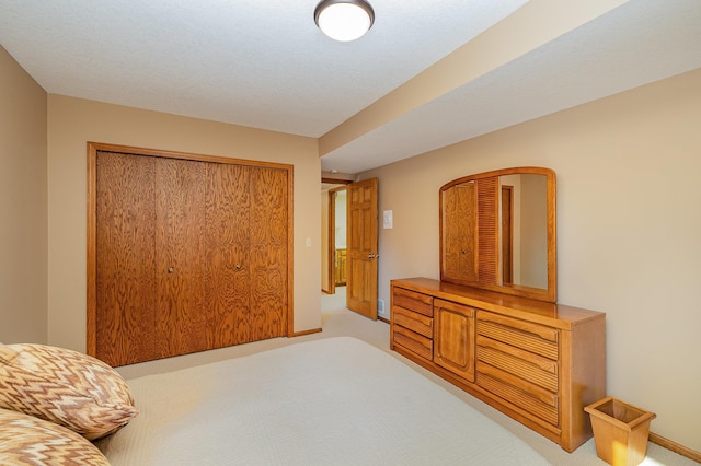 bedroom featuring baseboards, a closet, and carpet floors