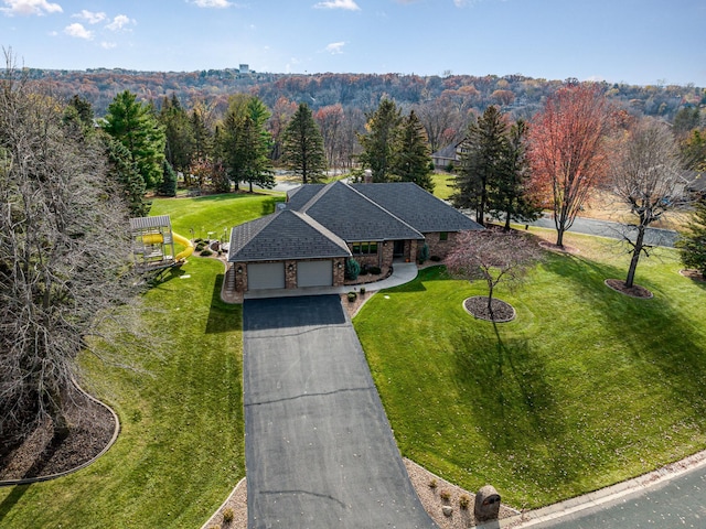 birds eye view of property with a wooded view