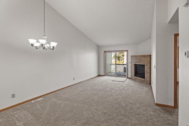 unfurnished living room featuring a fireplace, carpet flooring, an inviting chandelier, and high vaulted ceiling