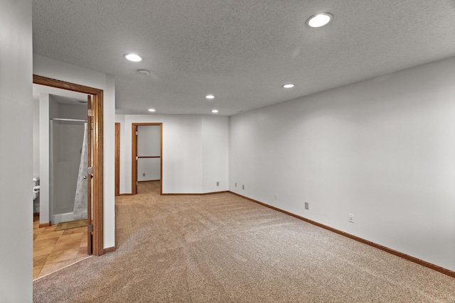 interior space with light colored carpet and a textured ceiling