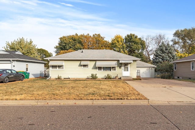 ranch-style house featuring concrete driveway and a front lawn