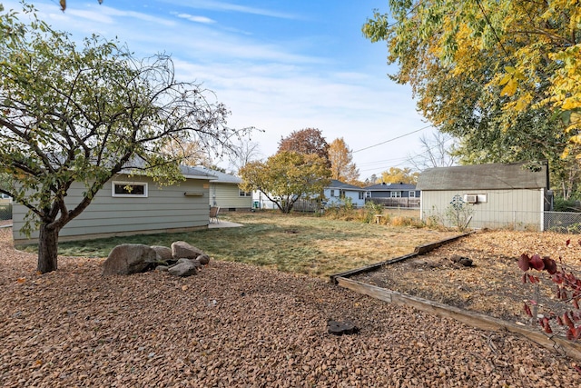 view of yard with an outbuilding and fence