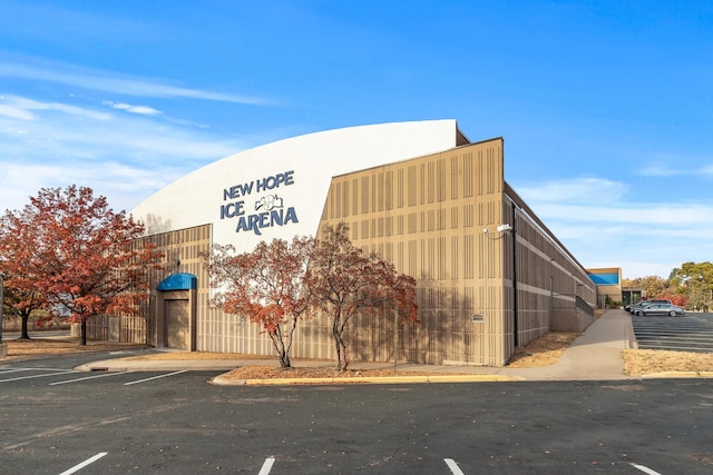 view of building exterior with uncovered parking