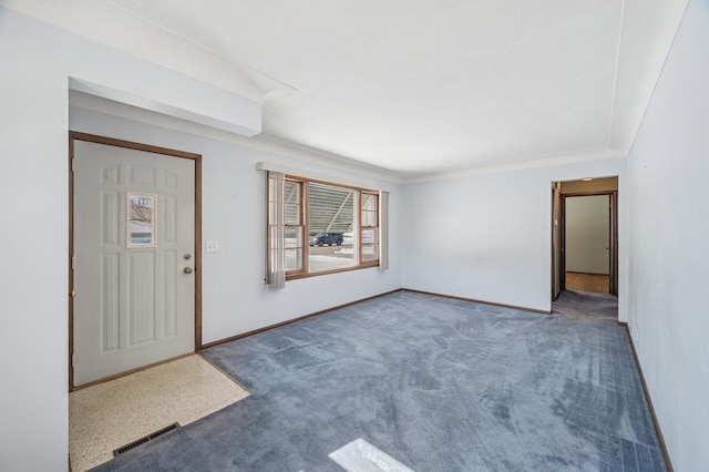 carpeted entryway featuring baseboards and visible vents