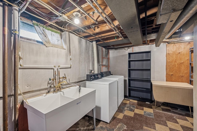 laundry room featuring a sink, separate washer and dryer, dark floors, and laundry area