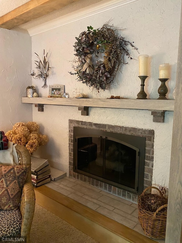 room details featuring carpet floors, beamed ceiling, and a brick fireplace