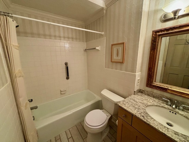 full bathroom featuring tile walls, toilet, ornamental molding, vanity, and shower / tub combo with curtain