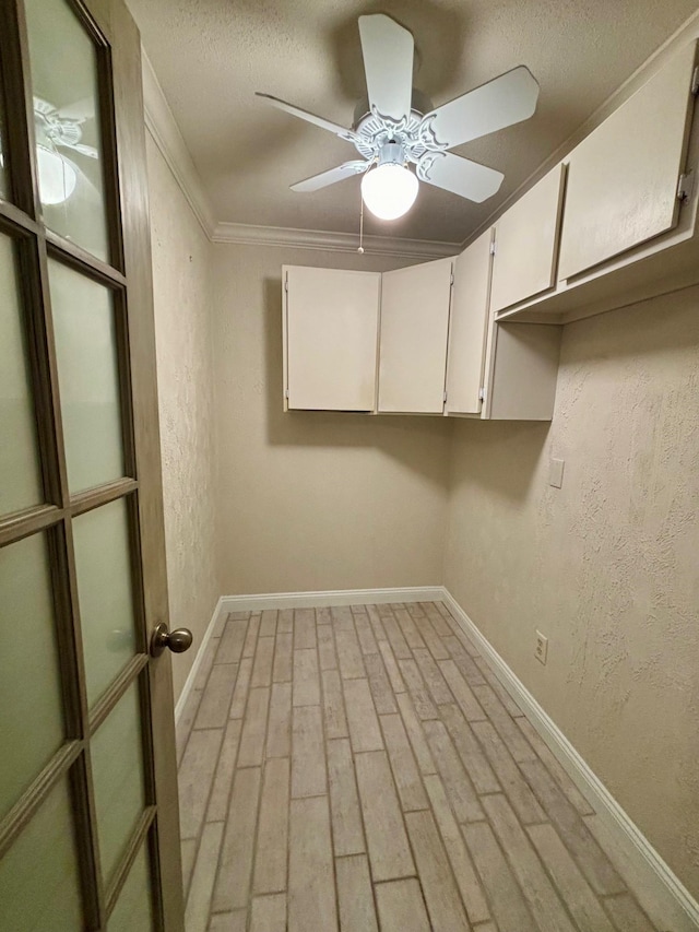 laundry area with ornamental molding and ceiling fan