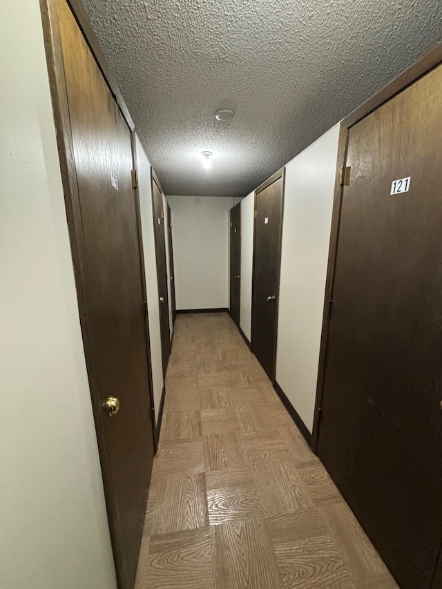 hall featuring a textured ceiling