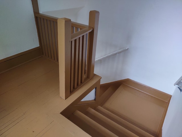 staircase featuring hardwood / wood-style flooring